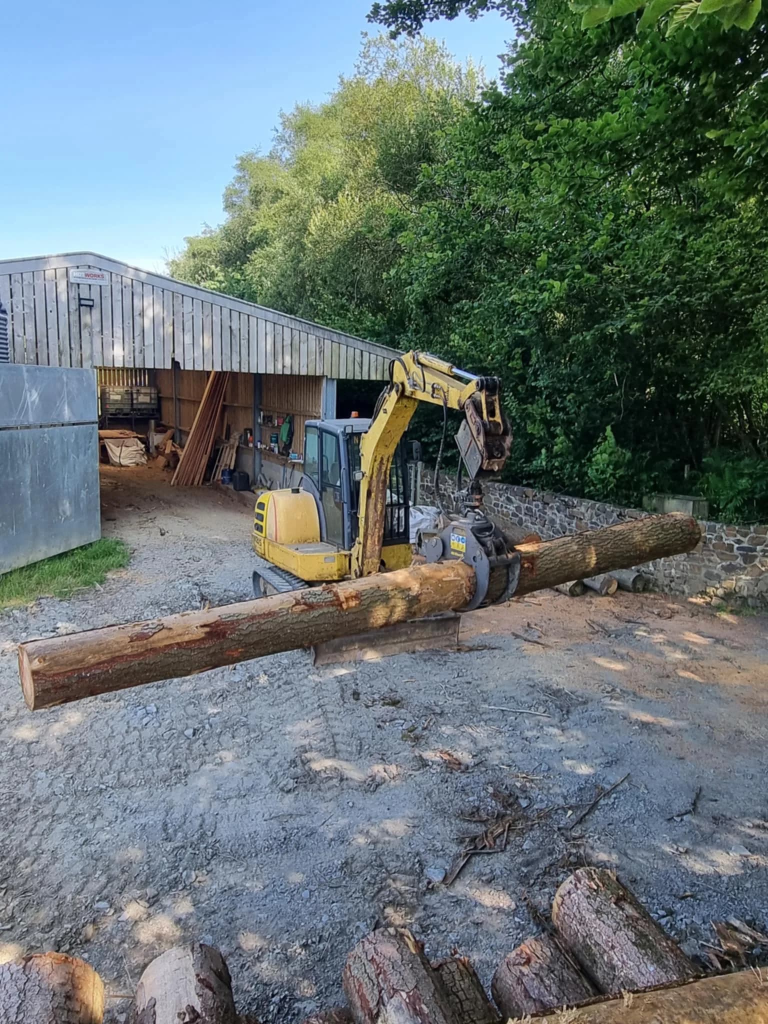 Excavator moving a log in the H.R.A yard